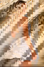 Back view of white bubble skirt short dress with jeweled detail