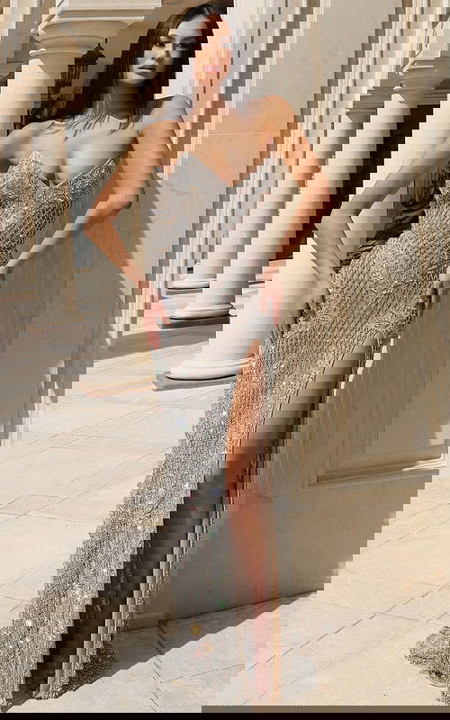 Silver beaded strapless gown with intricate pattern and high slit