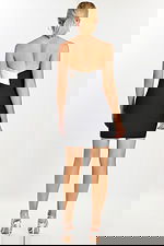 Back view of black and white crisscross halter mini dress