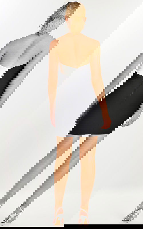 Back view of black and white crisscross halter mini dress