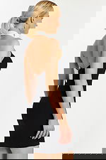 Side profile of two-tone fitted cocktail dress