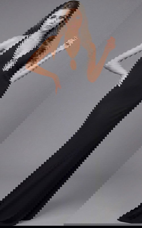 Front view of a fitted halter gown with crystal trim and deep neckline detail