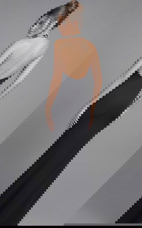 Back view of a fitted halter gown with open back and smooth floor length silhouette