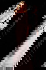 Sophisticated formal gown with draped waist, feather cuffs, and smooth satin finish