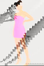 Side view of a strapless hot pink romper dress featuring a mini skirt overlay and waist buckle.