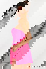 Close-up side view showing zipper and buckle detail on a hot pink romper with hand in pocket.