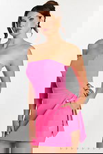 Front angle of a woman holding the overlay skirt of a hot pink romper with visible pocket.