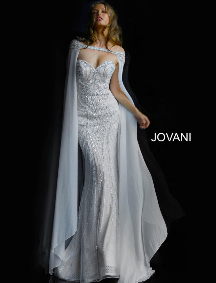 Model wearing Jovani 45566 ivory gown with sweetheart neckline and cape