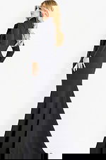 Long sleeve fitted gown with structured shoulders and a sweeping train, offering a sleek and sophisticated evening silhouette.