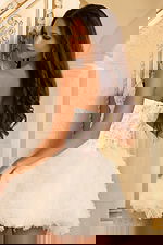 Back view of strapless ruffled tulle dress with floral details