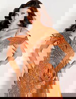 Off-shoulder beaded gown featuring an asymmetric ruffled bodice, thigh-high slit, and flowing tulle side train.