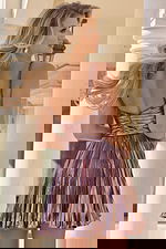 Back view of pleated metallic mini dress with thin straps