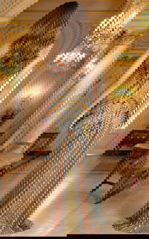 Back view of fully beaded gown with sheer illusion detailing