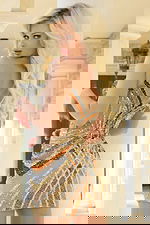 Back view of fitted dress with low cutout and colorful beadwork on mesh