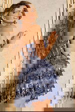 Back view of lace-up corset dress with layered skirt and shimmering accents