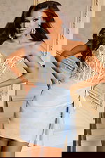 Back view of tie-up corset dress with fitted satin skirt and ruffle detail