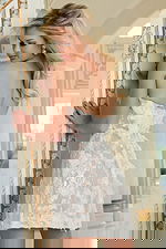 Back view of textured lace mini dress with illusion details and soft trim