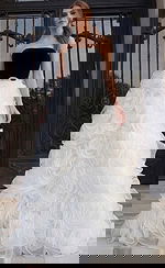 Strapless gown with black fitted bodice and voluminous white rosette skirt