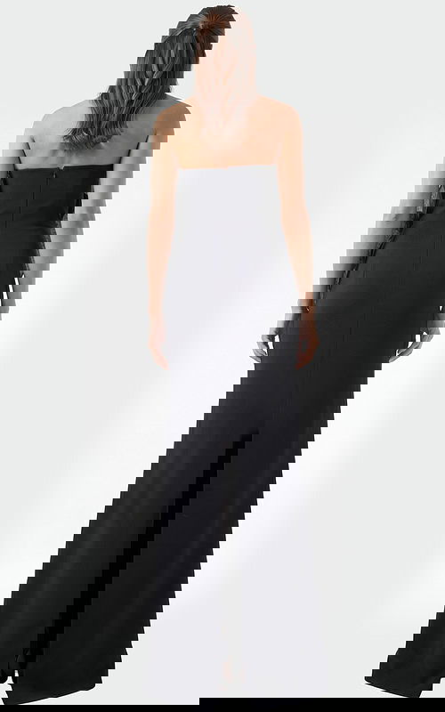 Back view of black strapless evening dress with smooth fitted silhouette and floor length hem