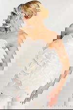 Side profile of model in off-white floral jumpsuit