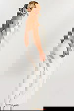 Over-the-shoulder pose showing back and side of white floral jumpsuit