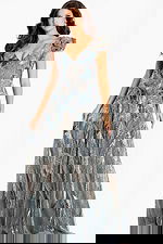 V-back glitter gown with sequin leaf patterns and soft ruffle shoulders