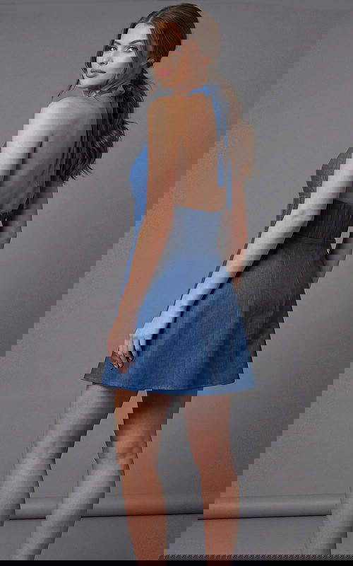 Back view of a halter mini dress with open back and flared skirt