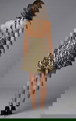 Back view of halter neck fit and flare mini dress with open back detail