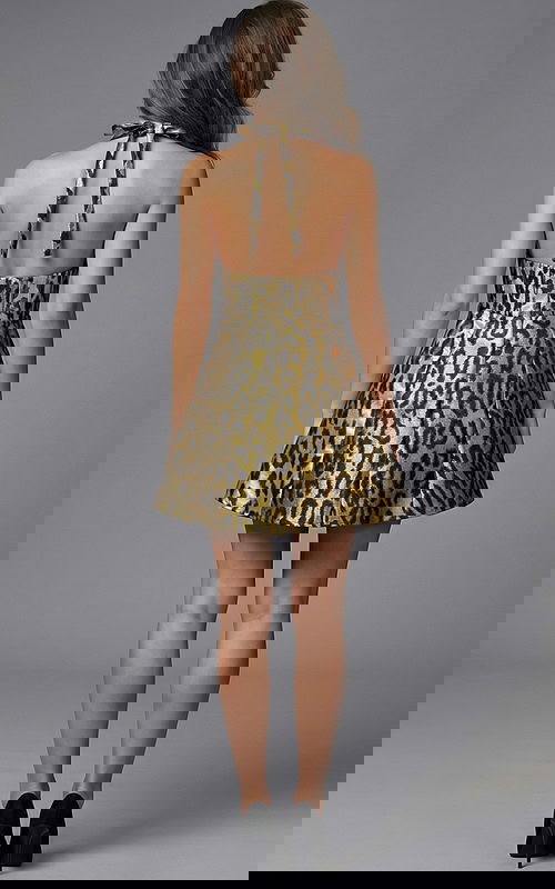 Back view of halter neck fit and flare mini dress with open back detail