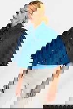 Side View of Structured Denim Cape with Wide Sleeves and Snap Button Detail