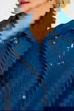 Close-Up of Snap Buttons and Zipper Hardware on Dark Blue Denim Cape Jacket