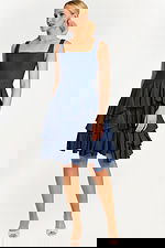 Side Angle of Sleeveless Denim Dress Showcasing Layered Skirt and Fitted Top