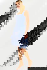 Model Wearing Sleeveless Denim Ruffle Dress with Square Neckline and Tiered Skirt