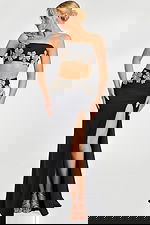 One shoulder black two-piece gown with large crystal flower appliqués and thigh-high slit