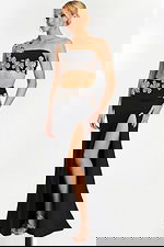 Black formal two-piece dress with floral beaded appliqués and high slit front view