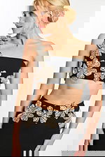 Close-up of crystal floral embellishments on black one shoulder crop top