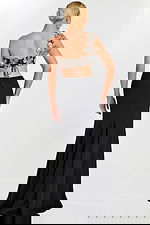 Back view of black skirt and floral lace-up crop top with flower appliqués