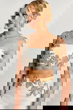 Close-up back of floral beading and strap on ivory crop top