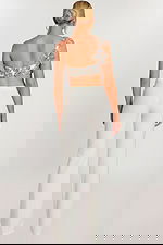 Back view of ivory jumpsuit with floral beaded strap and fitted pants