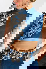 Close-up of beaded floral crystal details on denim top and waistband