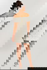 Back view of off-white dress with exposed zipper and fold-over neckline