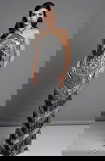 Front view of a fitted halter gown with geometric beading and fringe detailing