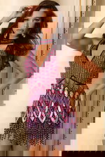 Beaded halter dress with geometric pattern and playful hem