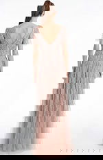 Back view of a beaded A line gown with V back and soft floor length silhouette