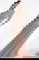 Side view of a beaded A line gown highlighting the sheer overlay and defined waist