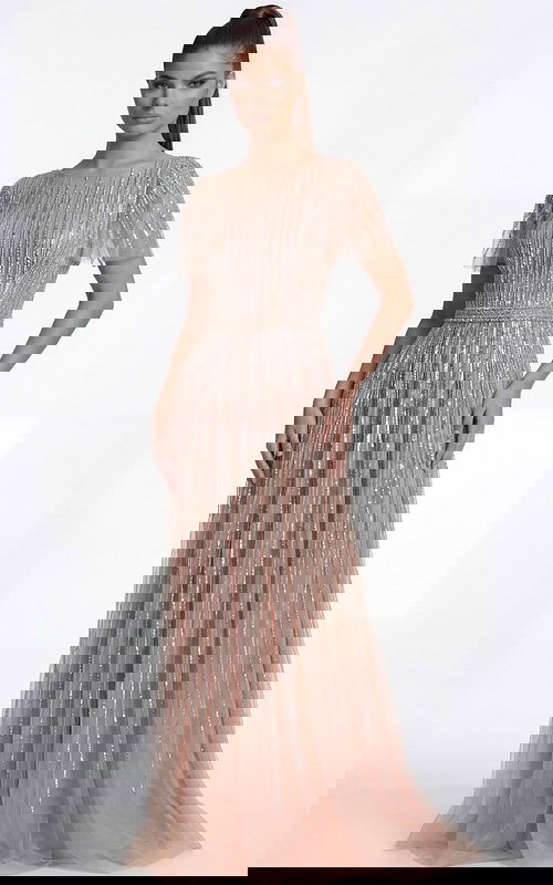 Side view of a beaded A line gown highlighting the sheer overlay and defined waist