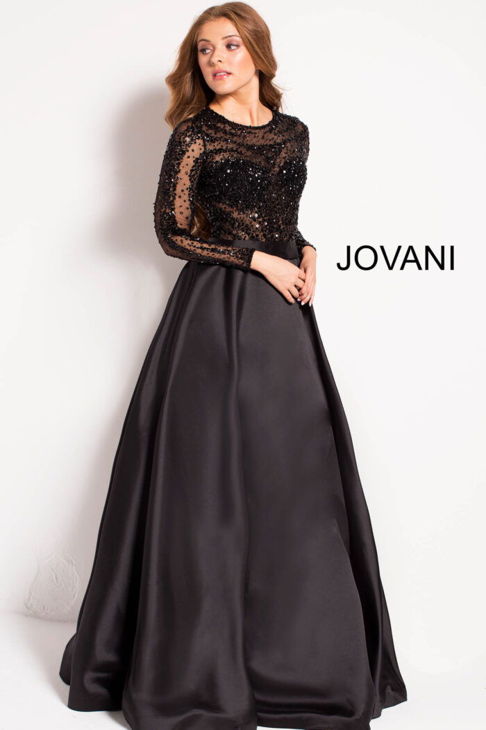 Model wearing Jovani 46066 black gown showing back detail and sheer sleeves