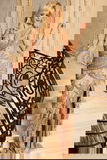 Glamorous full-length gown with cutouts and silver fringe