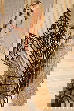 Sequin evening dress featuring deep slit and layered fringe detailing