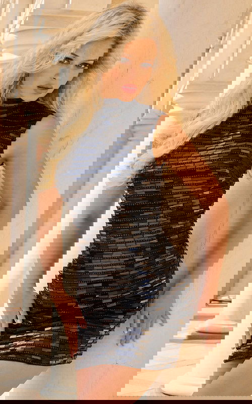 Woman Wearing High Neck Sequin Mini Dress With Sleek Design